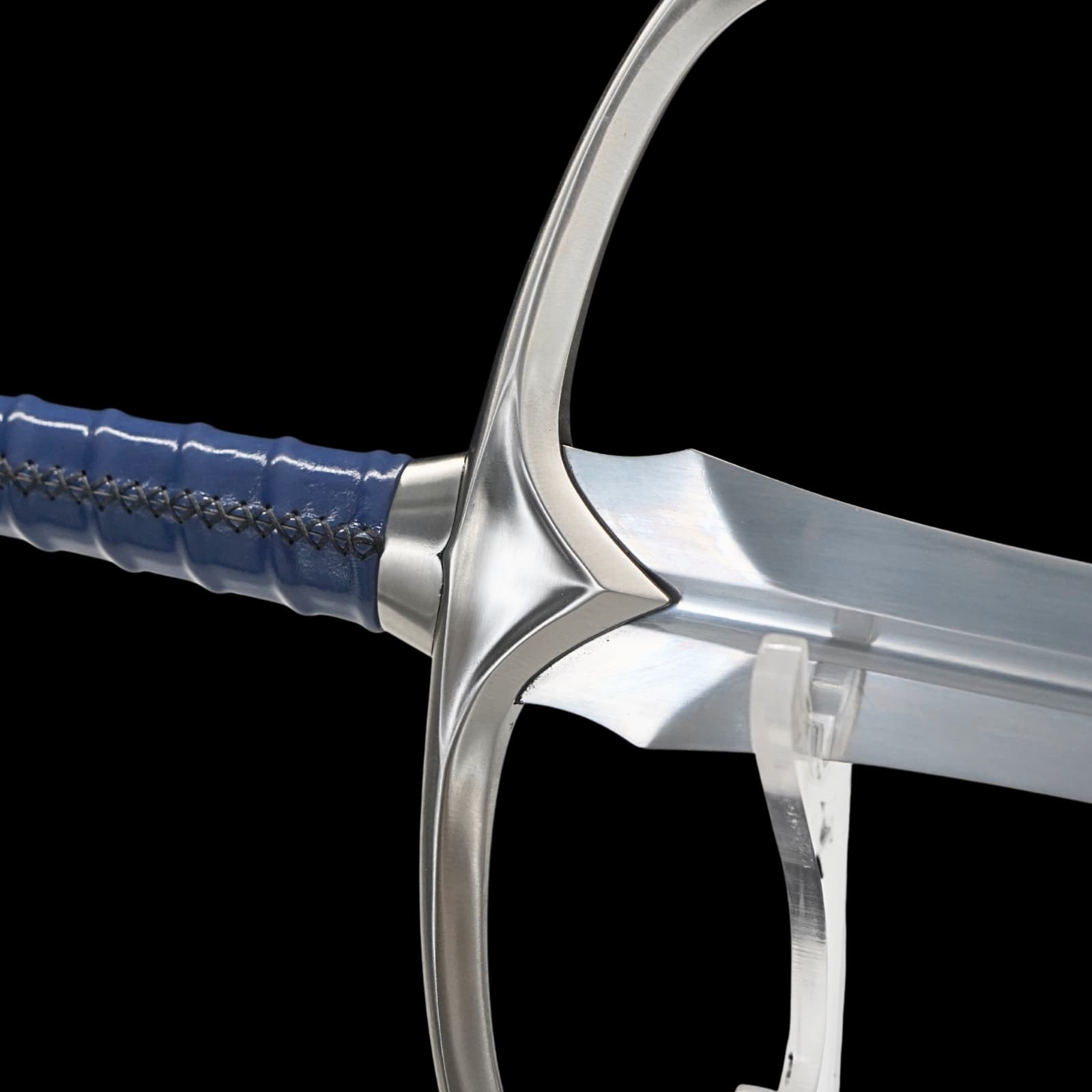 Close-up of a sword with a blue handle on a black background