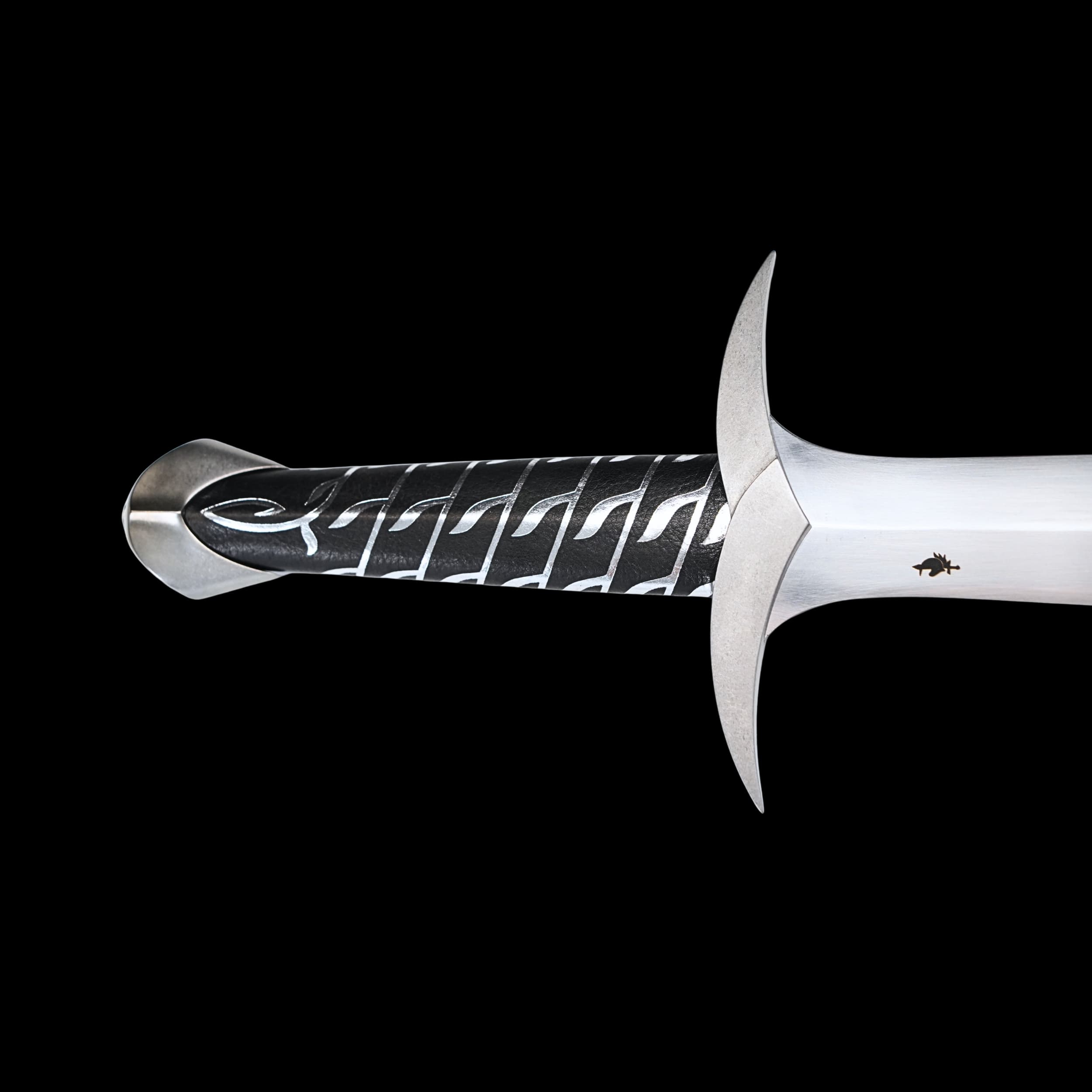 Decorative sword with intricate handle design on a black background