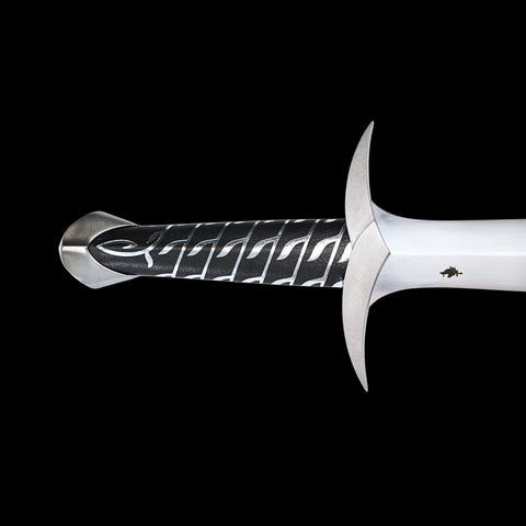 Decorative sword with intricate handle design on a black background