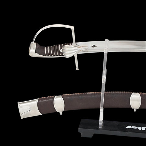 Sword with silver hilt and brown sheath on a black background