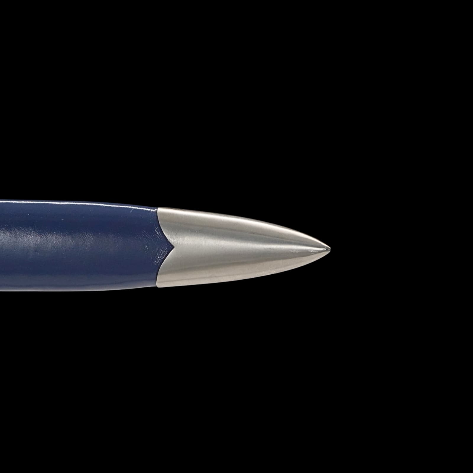 Close-up of a blue and silver pen tip on a black background