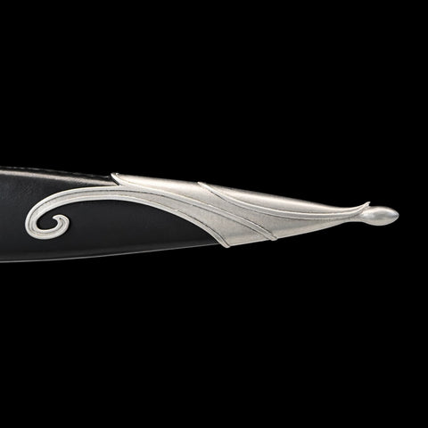 Decorative knife blade with silver handle on a black background
