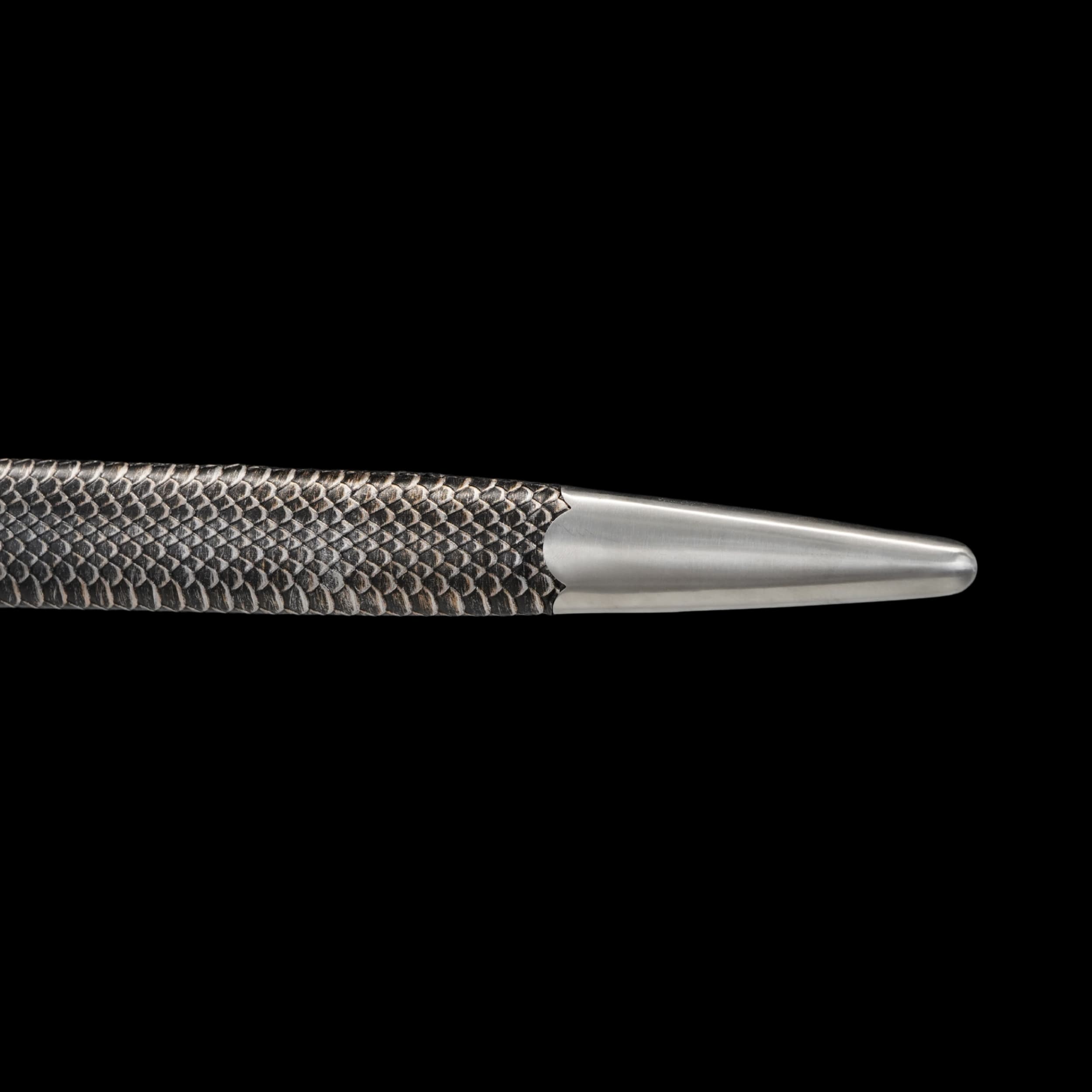 Close-up of a textured scabbard on a black background