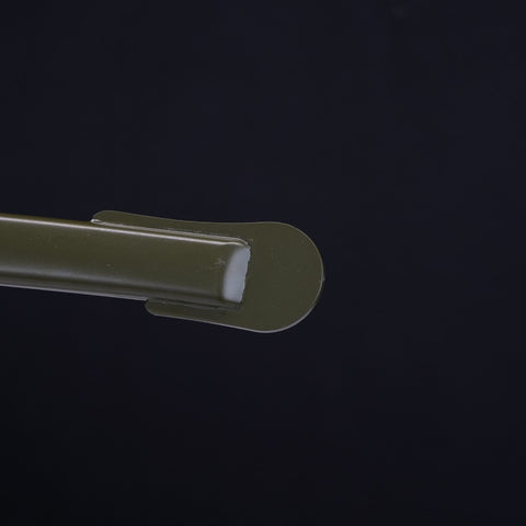 Close-up of a green plastic clip on a black background