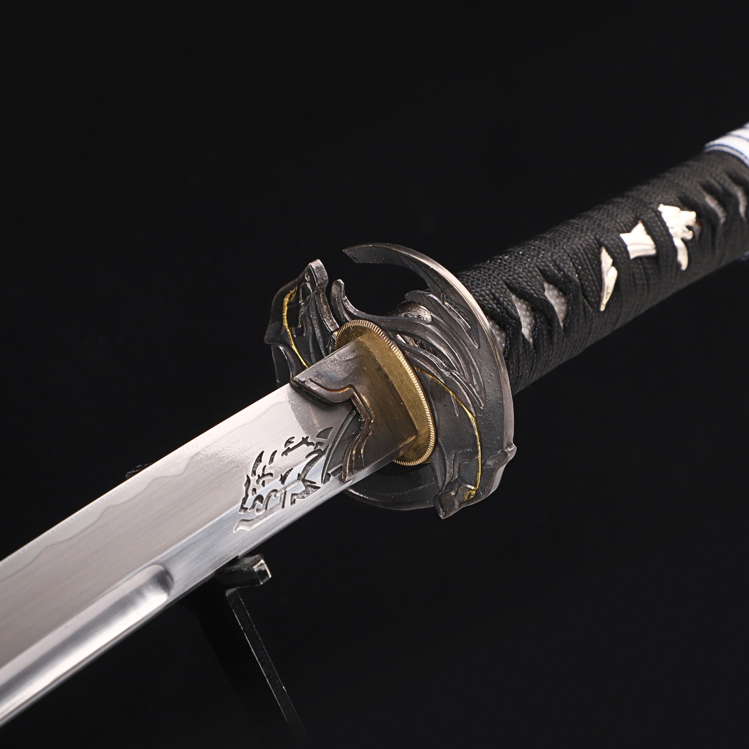 Close-up of a sword with a black handle and silver blade on a dark background
