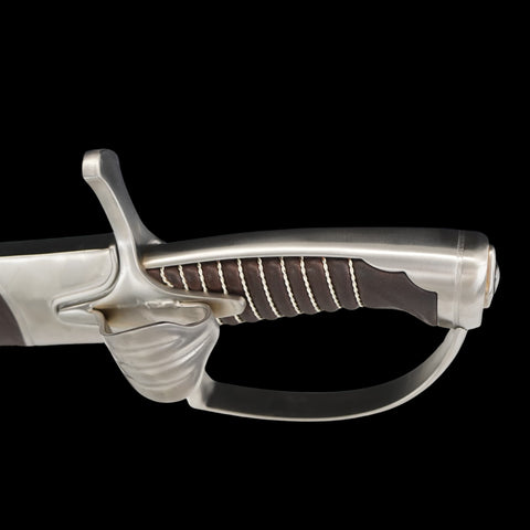 Decorative sword hilt with intricate design on a black background