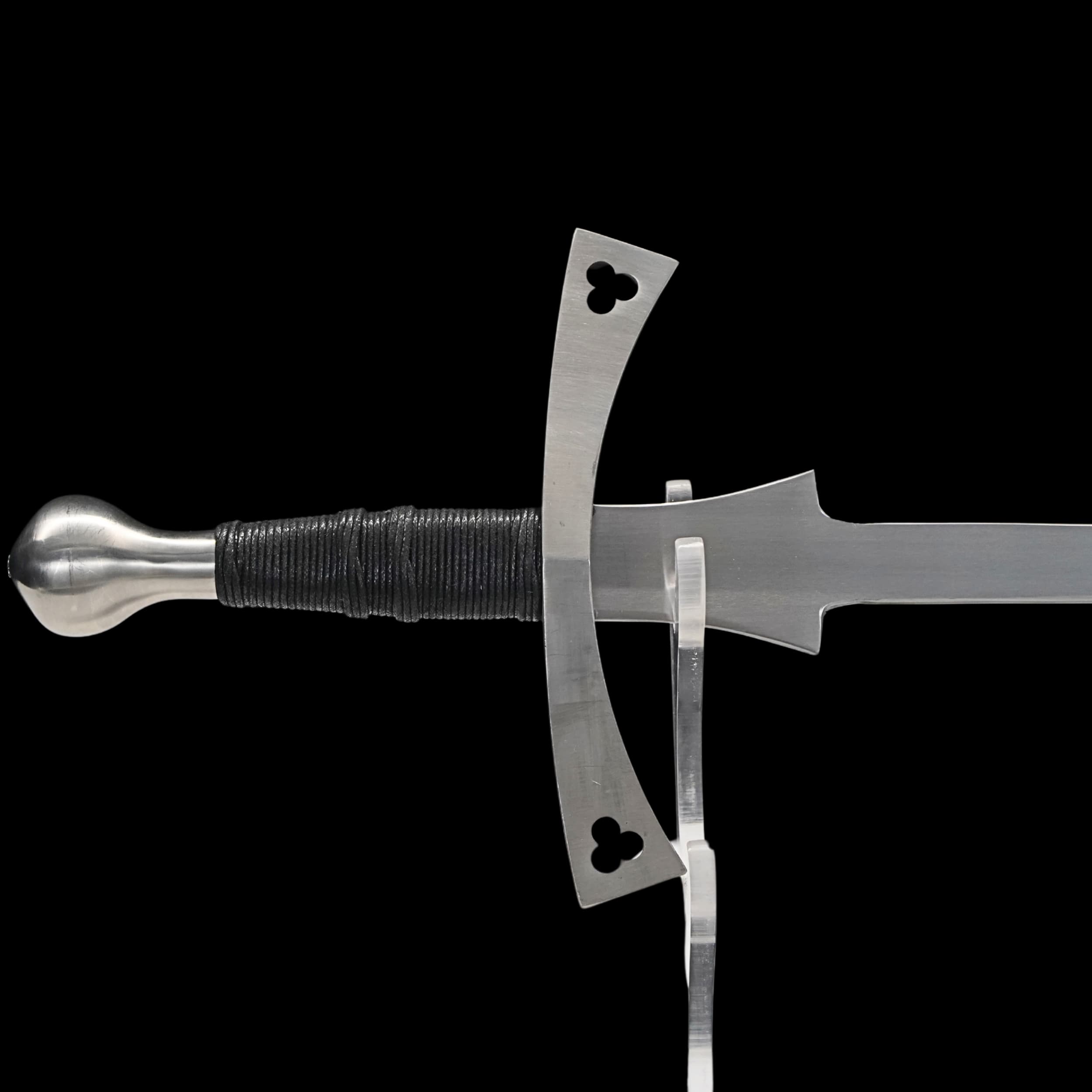 Sword with decorative pommel and hilt on a black background