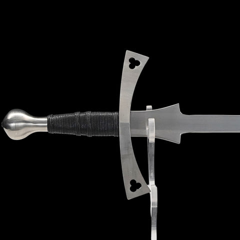 Sword with decorative pommel and hilt on a black background