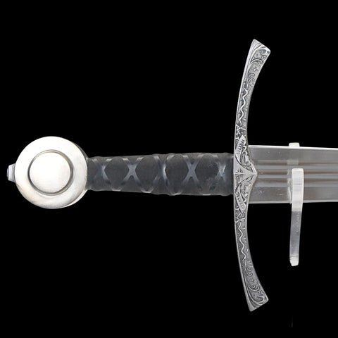 Decorative sword with detailed hilt on a black background