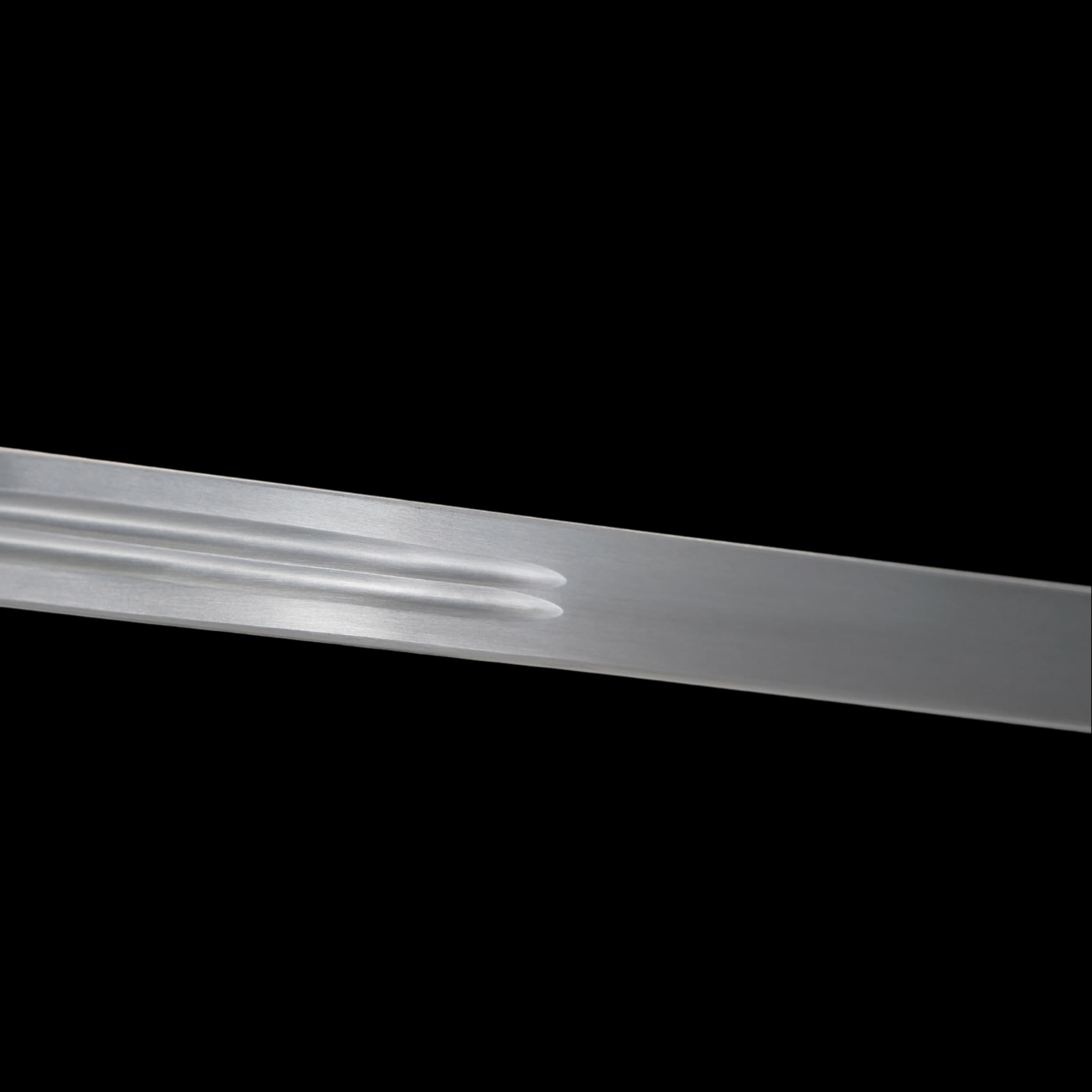 Metallic object with ribbed design on a black background
