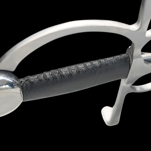 Close-up of a metallic equestrian bit with leather mouthpiece on a black background