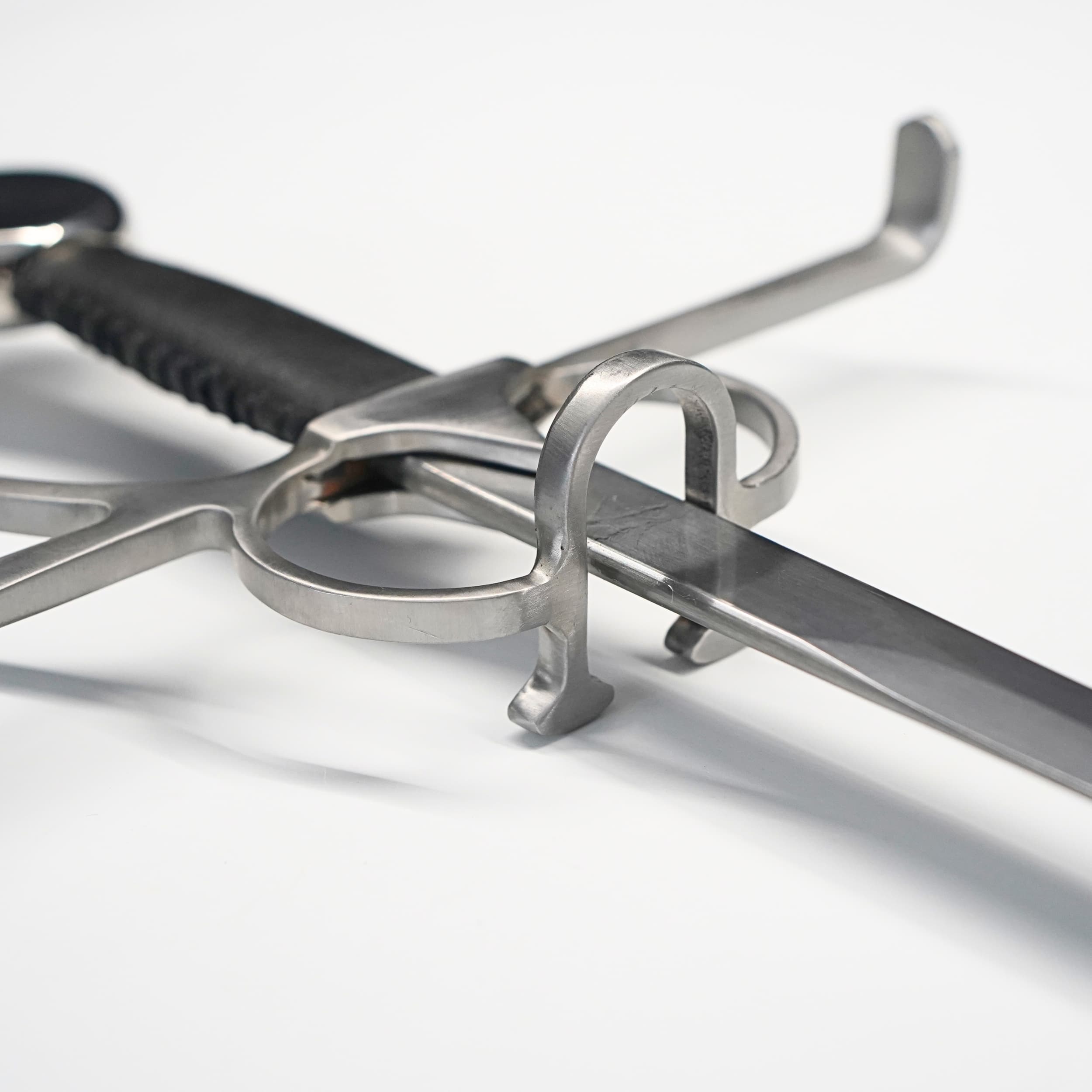 Close-up of a sword with a detailed hilt on a white background