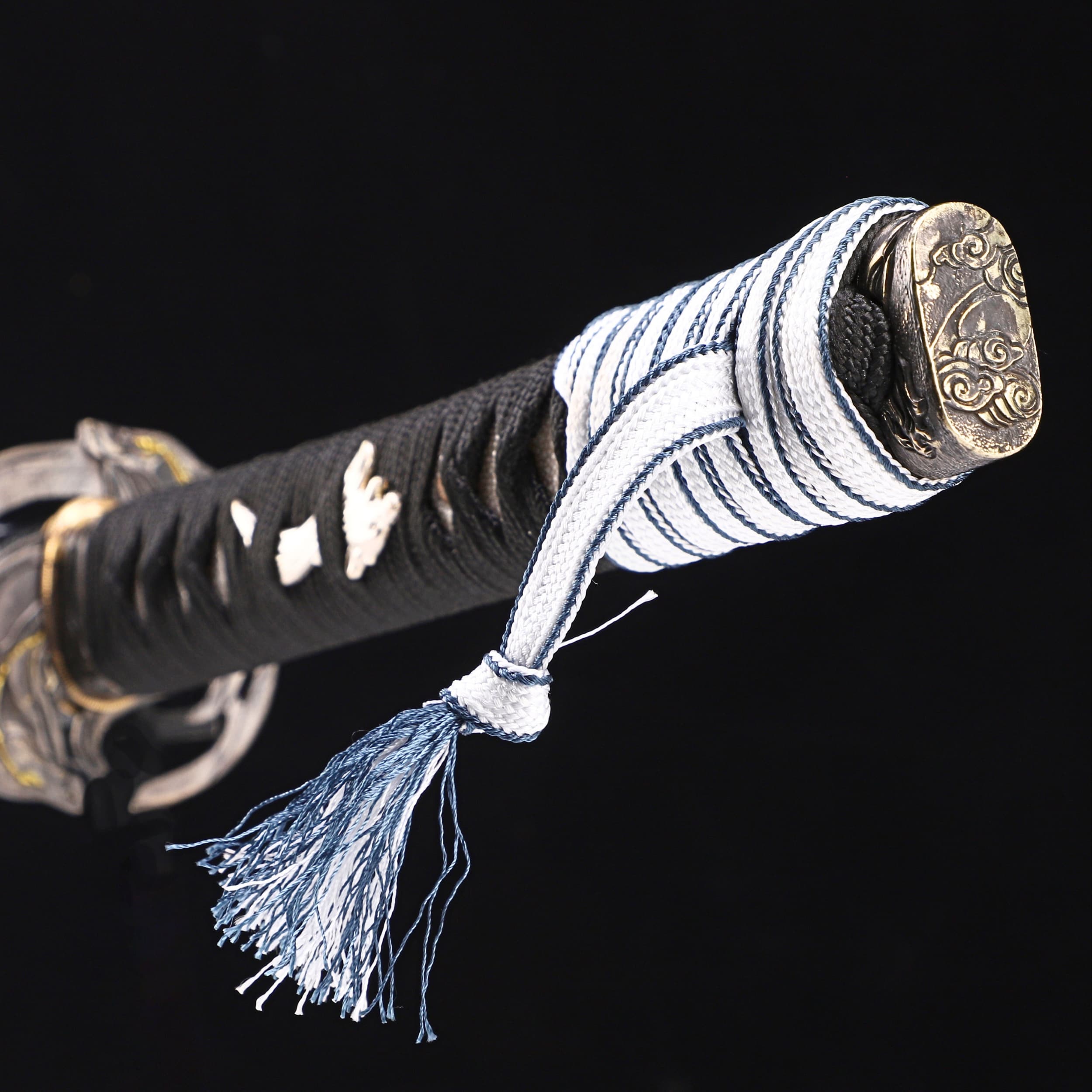 Sword with black sheath and decorative handle on a black background