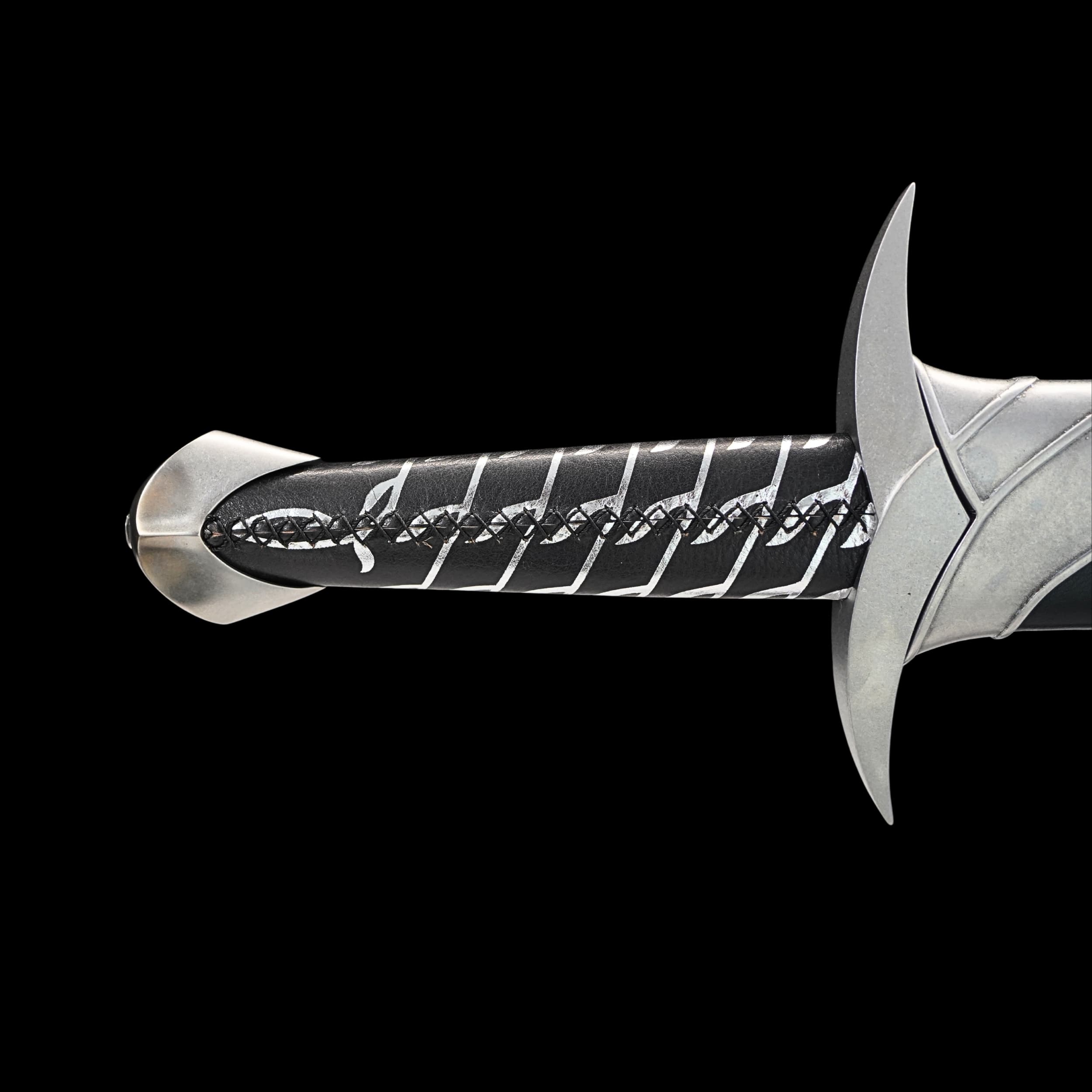 Silver sword with engraved handle on a black background