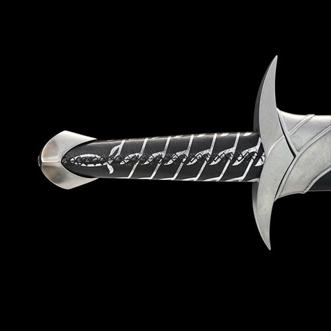 Silver sword with engraved handle on a black background