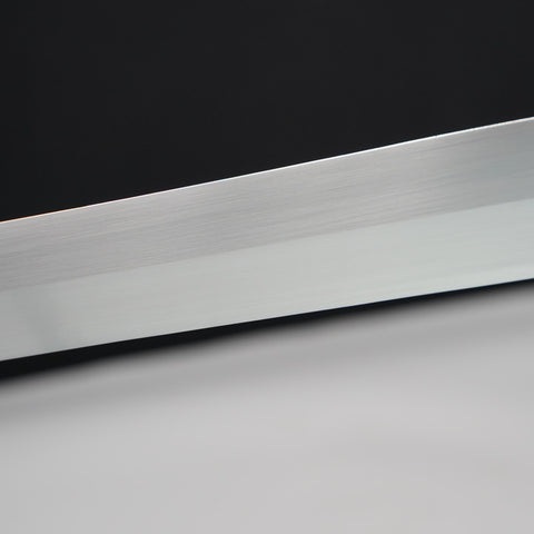 Close-up of a metallic blade on a black and gray gradient background
