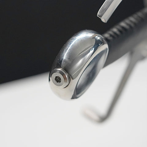Close-up of a metallic pen cap on a white surface