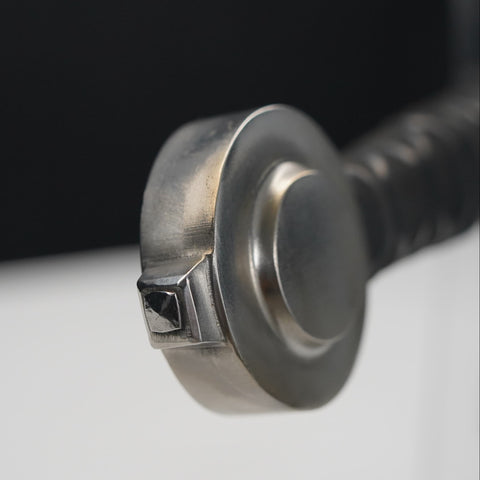 Close-up of a metal screw with a black handle on a white background