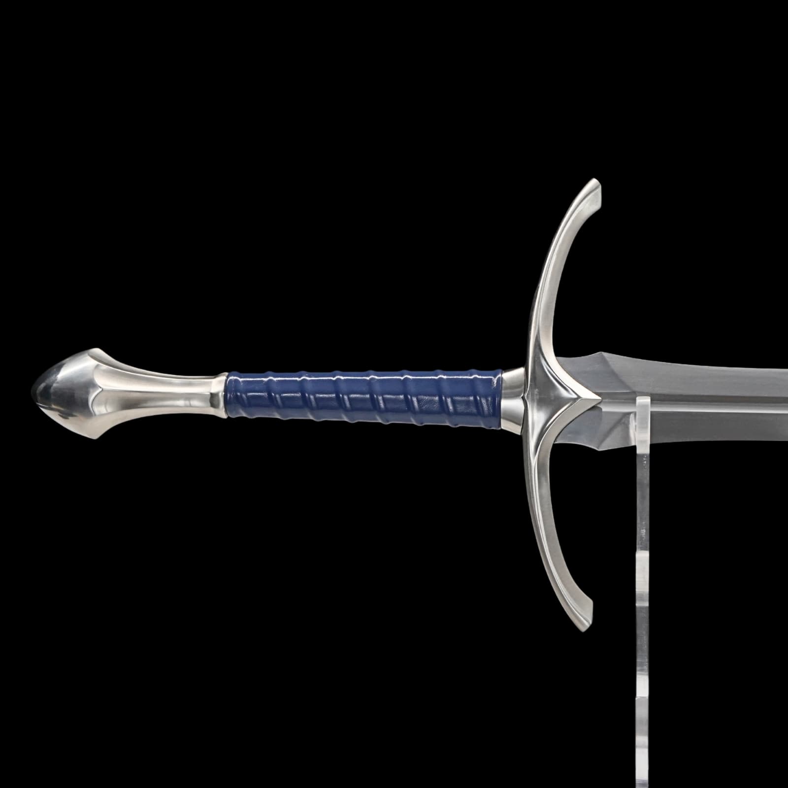 Sword with blue handle on a clear stand against a black background
