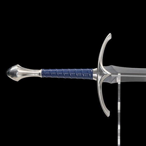 Sword with blue handle on a clear stand against a black background