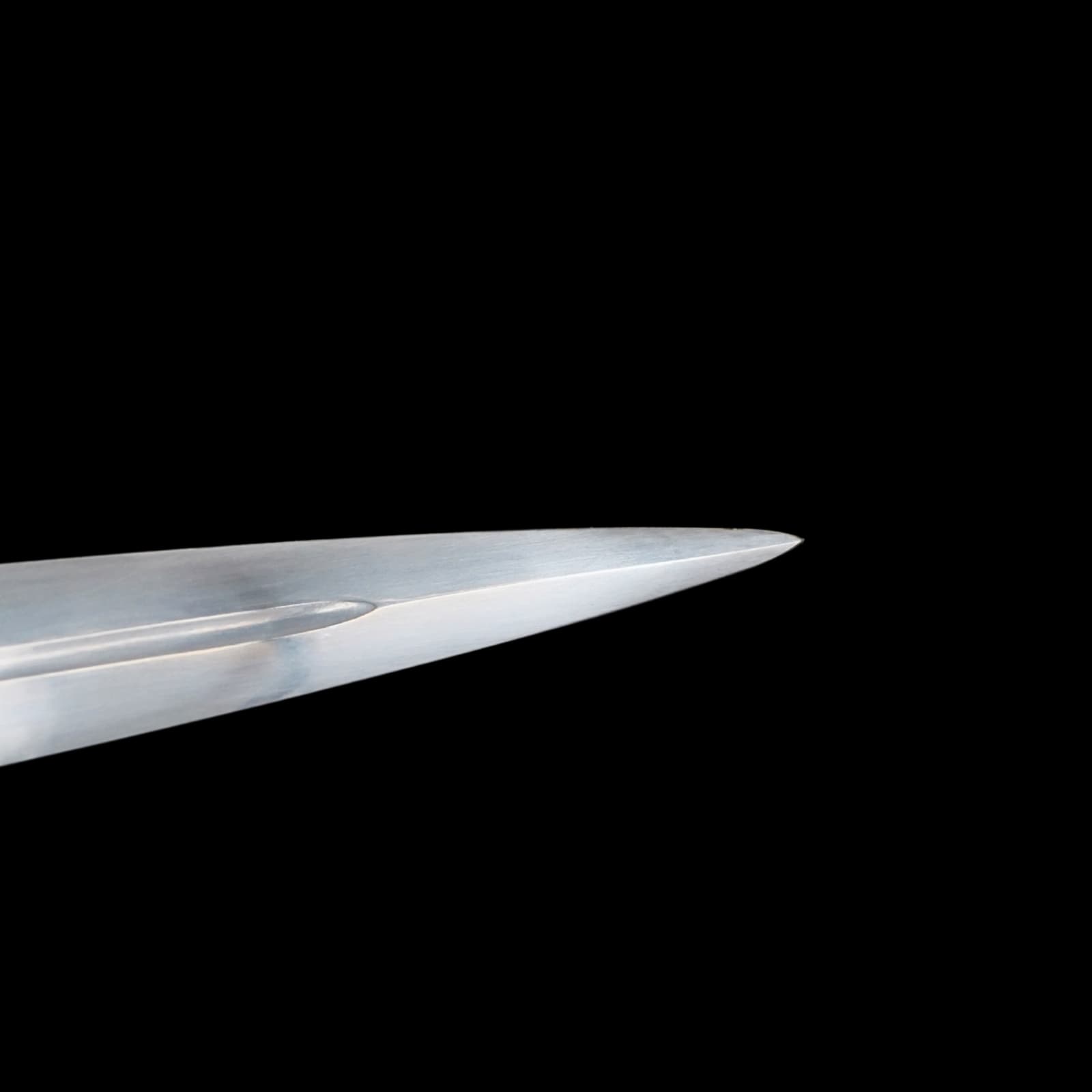 Close-up of a sword blade on a black background