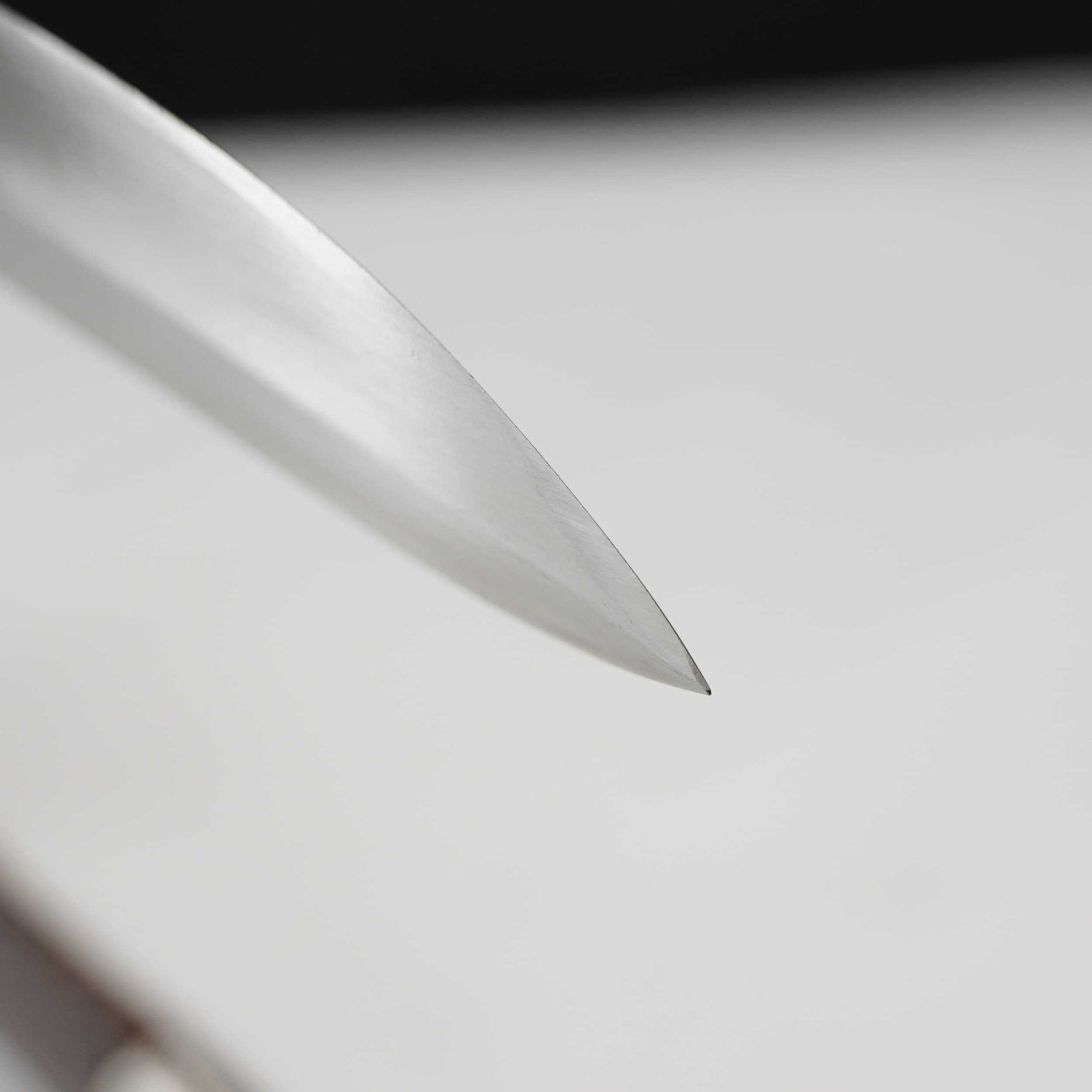 Close-up of a metallic object on a light gray background