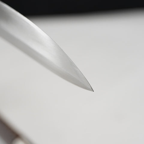 Close-up of a metallic object on a light gray background