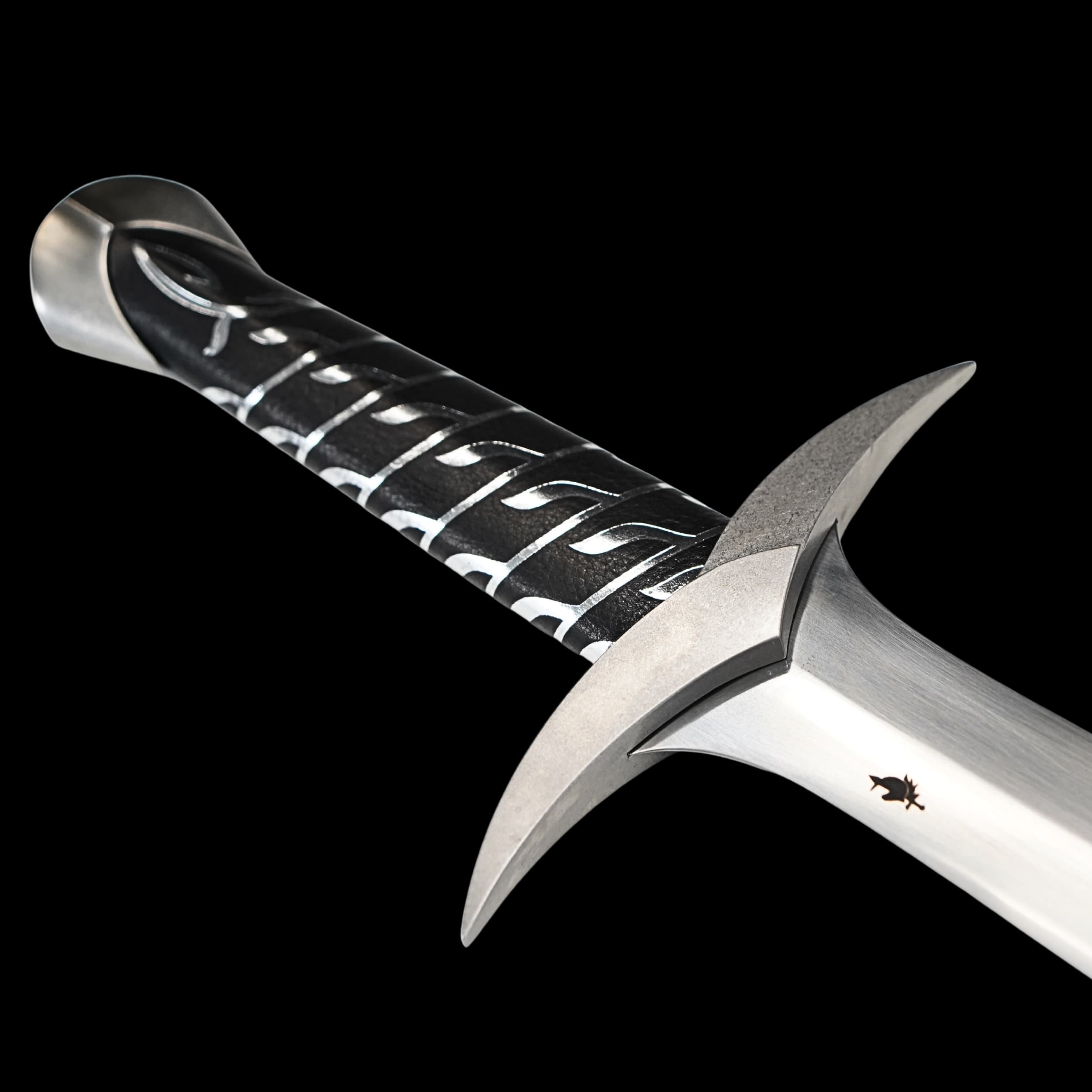 Close-up of a sword with a detailed handle on a black background