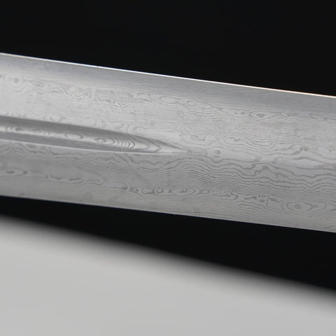 Close-up of a Damascus steel knife blade on a black and gray gradient background