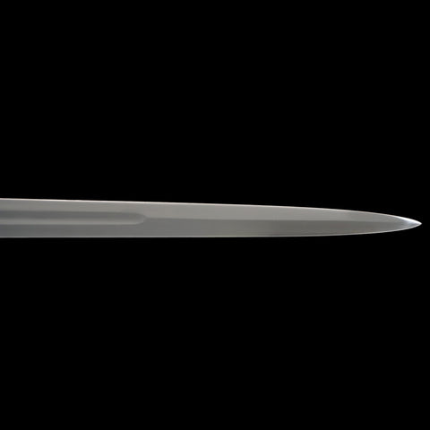 Long, thin metallic object on a black background